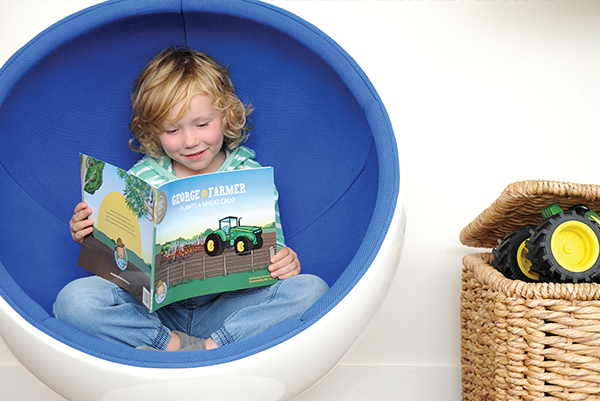 2014: George Kain finally with his hands on a copy of George the Farmer Plants a Wheat Crop — two years after conceptualising the idea with him.